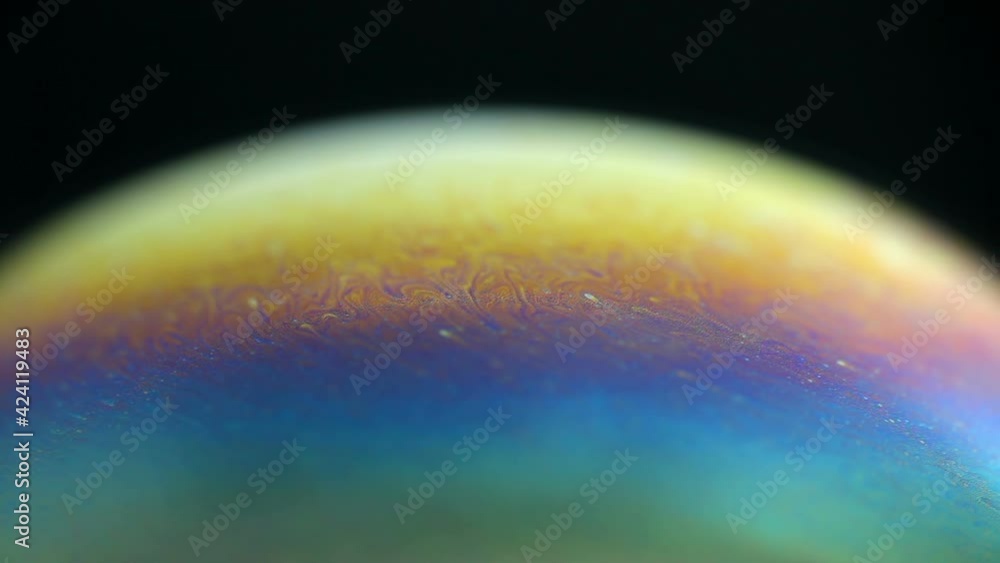 Sticker rotating colorful rainbow bubble on black background. abstract backdrop