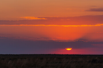 Red or orange sunset sky with stormy clouds