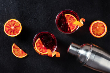 Negroni cocktails, overhead flat lay shot with blood oranges and a shaker