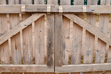Wooden fence made of wooden narrow boards. Background and texture