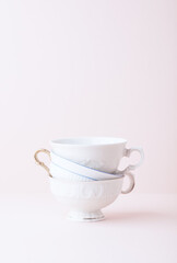 Stack of ceramic cups on bright background. Close up.	