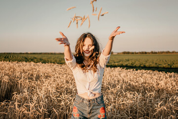 Wheat crop, harvest, Harvesting agriculture, economy. Young brunette woman with hands full of ripe...