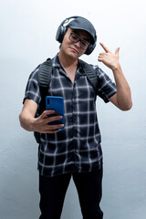 young man listening to music with his headphones taking a selfie