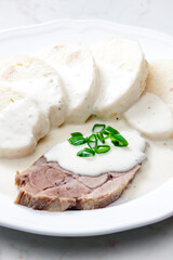meat with cream sauce and dumplings