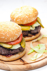 homemade hamburger with pickled cucumber and tomato