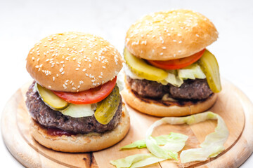 homemade hamburger with pickled cucumber and tomato