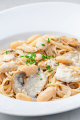 spaghetti with creamy mushroom sauce, chicken and beans