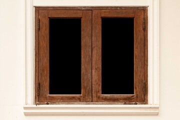 Old brown wooden windows and light cream cement walls