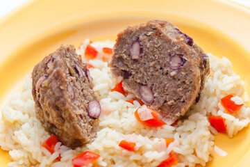 meat balls filled with red beans on rice with red pepper