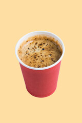 Coffee to go in a paper red glass without a lid on a terracotta background top view close-up vertical format