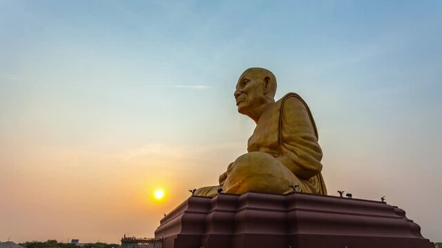 timelapse sunrise at the big Buddhist Monks Luang Phor Tuad Statue At Buddha Uttayarn Maharach Project Ayutthaya, Thailand .