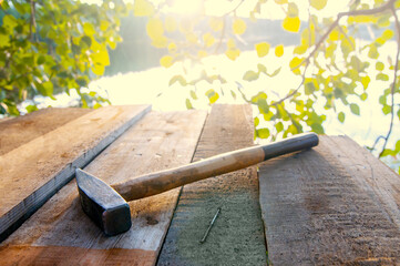 hammer and nail on boards. Sun flare
