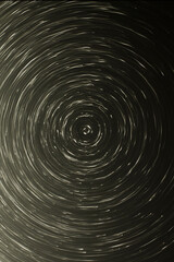 white and black light particles in a circular rotation