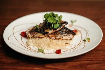 Grilled fish with couscous porridge and parsley