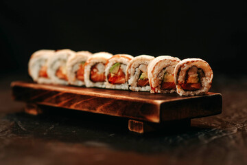 Sushi set with eel and avocado on a black background