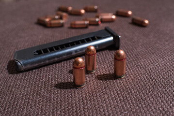 Copper firearms bullets and pistol clips. Weapon
