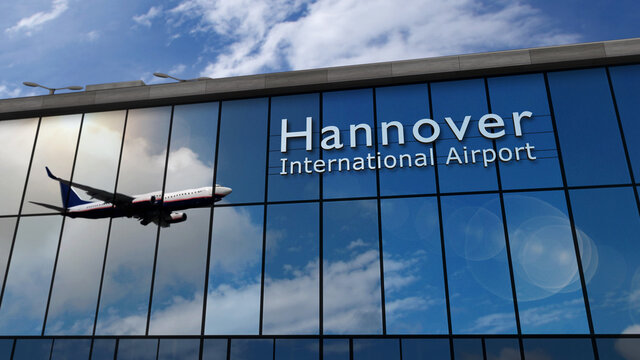 Airplane landing at Hannover Germany airport mirrored in terminal
