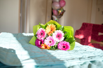 bouquet of flowers on the bed