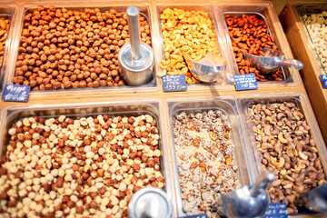 Many different nuts are sold on the counter in the store.