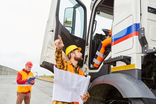 Road Construction Foreman Talks To Truck Driver