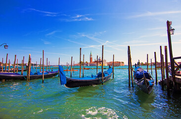 Plakat Traditional blue gondola moored in St. Mark's Square with the Church of San Giorgio di Maggiore on the background, Venice, Italy. Famous Italian landmark and Venetian symbol. Soft focus