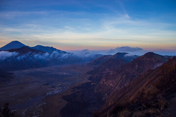 Naklejka na ściany i meble Terrific Bromo Tengger Semeru National Park on East Java, Indonesia. Aerial view of erupting volcano Bromo, Mount Semeru and Mount Batok from Penanjakan view point, observation area to see sunrise.