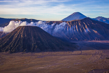 Beautiful caldera with erupting and active Bromo volcano, mount Batok and volcano Semeru on the backgrounbd. Bromo Tengger Semeru National Park, East Java, Indonesia.