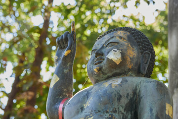 Fototapeta na wymiar Phayao, Thailand - Dec 13, 2020: Right Frame Headshot The Birth of Buddha Statue on Forest Background in Wat Analayo Temple