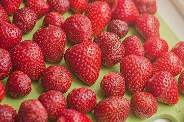 Peeled red ripe strawberries. Summer time background.