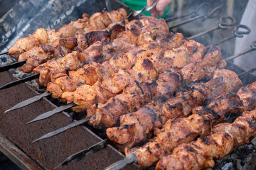 A man cooks meat on coals. Selective Focus