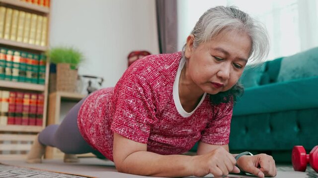 Healthy senior woman exercise with elbow plank pose