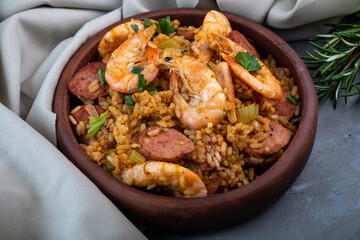 Cajun cuisine. Jambalaya with shrimps and tomatoes close-up. 