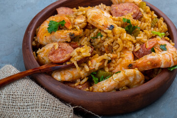 Local food jambalaya with shrimps, waffles and smoked sausages . A dish of Cajun cuisine. Close-up.