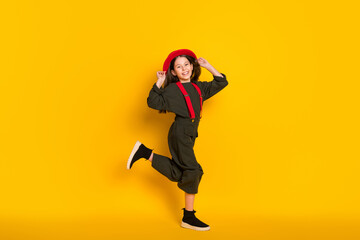 Fototapeta na wymiar Full length body size view of attractive cheerful girl posing having fun good mood isolated over bright yellow color background