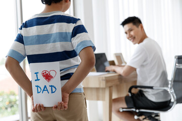 I love you, dad. Asian Happy family son Surprise, made a greeting card for Daddy on Father's Day. conecept.