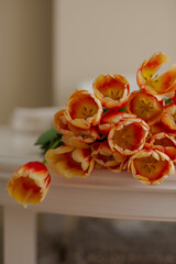 Bright tulips lie on the table. Blooming tulips. Spring bouquet of flowers. Beautiful flowers. Mothers Day