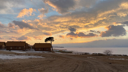 Naklejka na ściany i meble Stunning sunset on Olkhon island. Northern landscape near the frozen Lake Baikal.