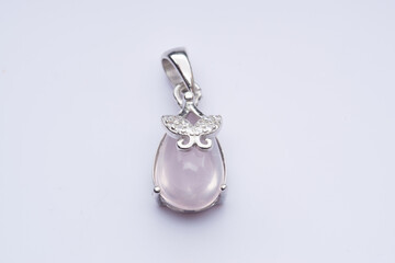 Silver pendant with natural rose quartz on a white background