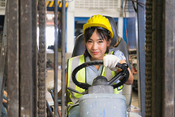 Cute Asian engineer worker women driving forklift in factory-warehouse