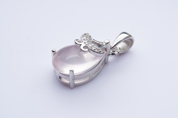 Silver pendant with natural rose quartz on a white background