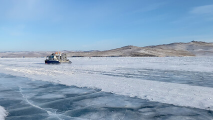 A car with a bottom on an air cushion glides on the ice of frozen Lake Baikal.