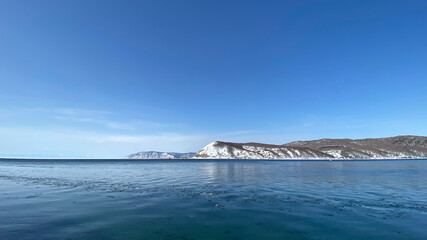Fototapeta na wymiar The non-freezing Angara river near Lake Baikal. Northern landscape of frozen Lake Baikal.