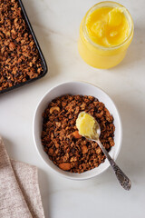 Homemade chocolate granola with ghee on a light background. Healthy food concept.