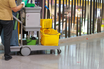 The cleaning staff car in the mall cleans the floor and a lot of cleaning supplies in it.