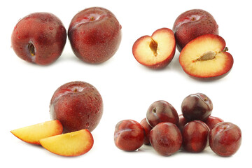 fresh red plums and some pieces on a white background