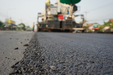 The image is blurred in the construction of asphalt road.