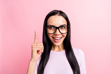 Portrait of young beautiful attractive happy positive genius girl in glasses find solution isolated on pink color background