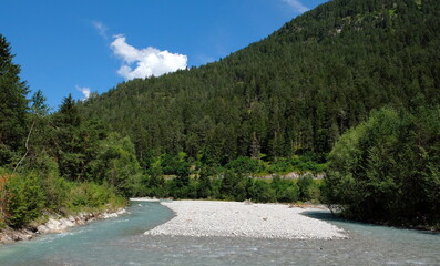 valley with river waterfall and trees in open nature