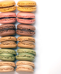 several multi-colored macaroon cakes on a white background