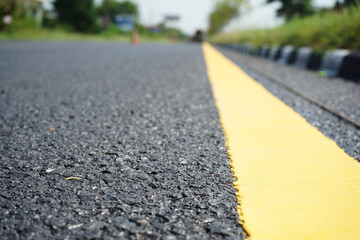 Fototapeta premium Yellow traffic lines and trees